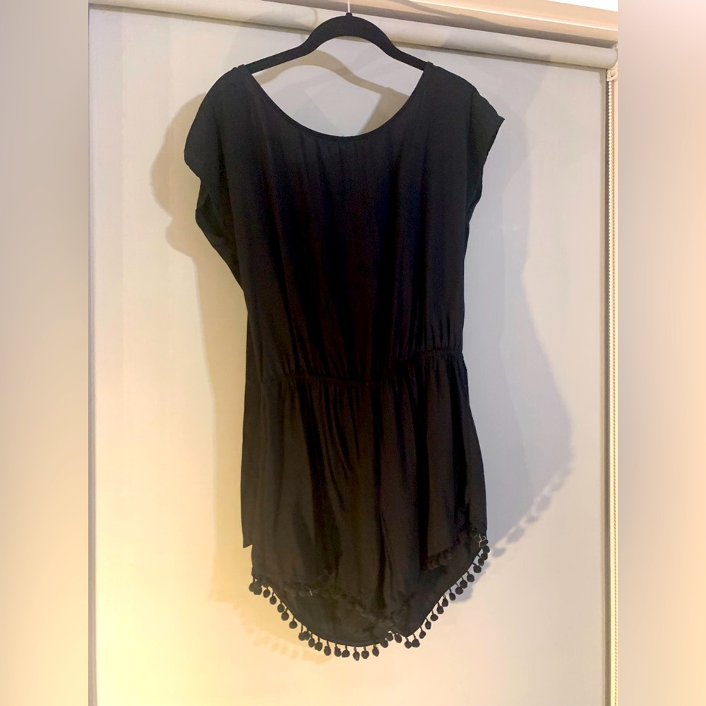 Black romper with pompom and tie back detail